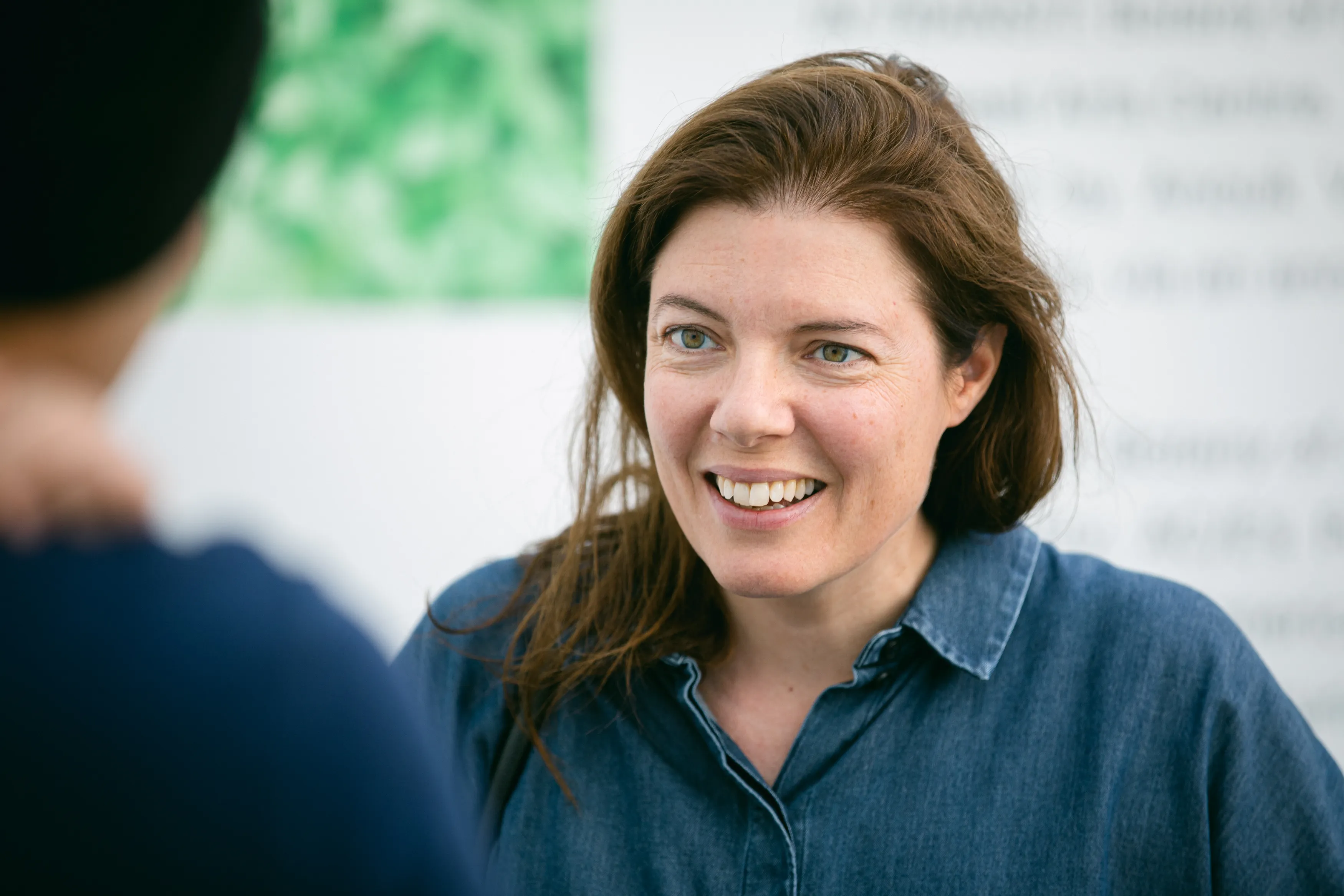 Close-up of Antonia Carver in conversation with someone off-camera.