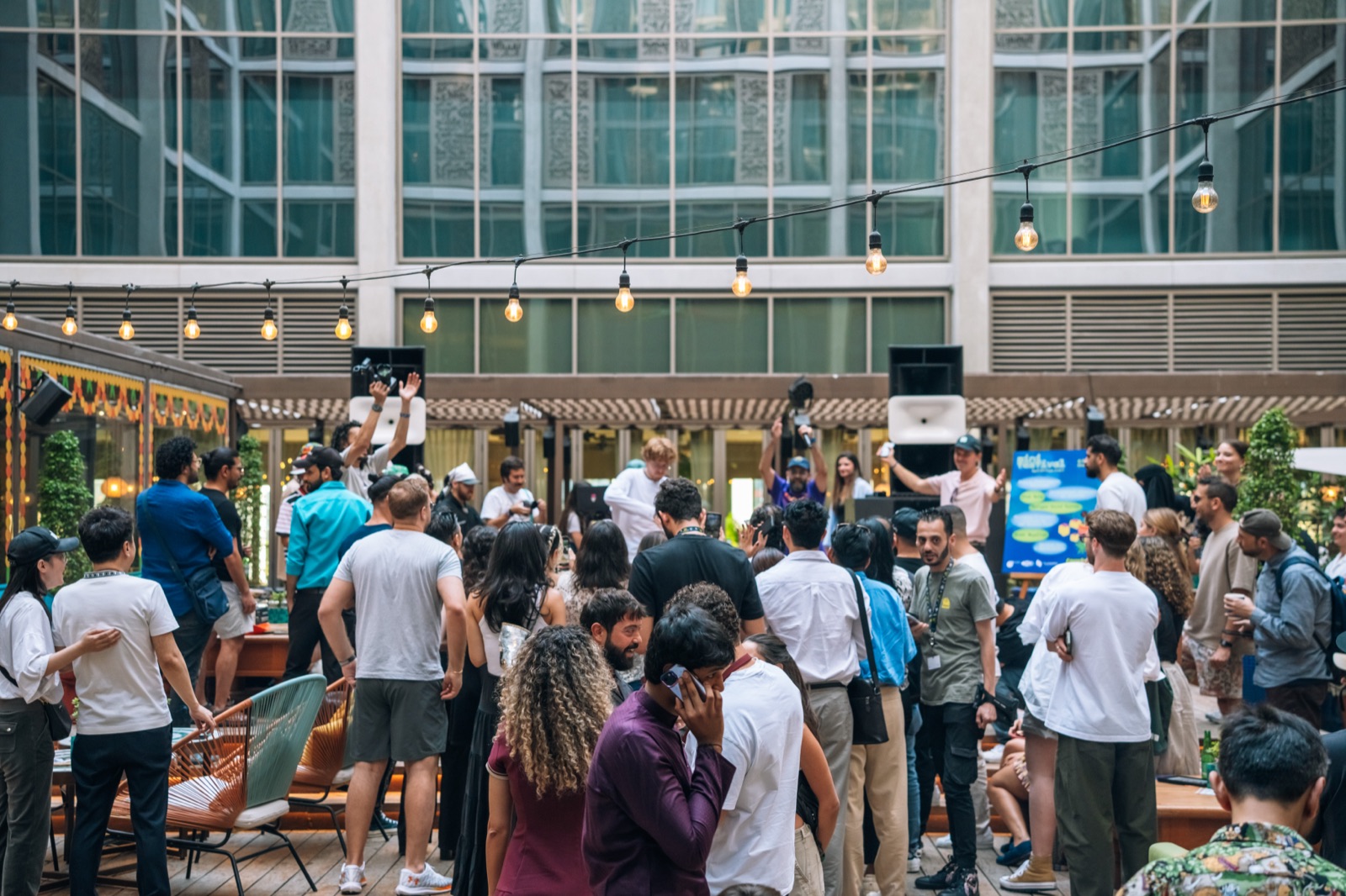 A crowd gathered in a courtyard around a performance.
